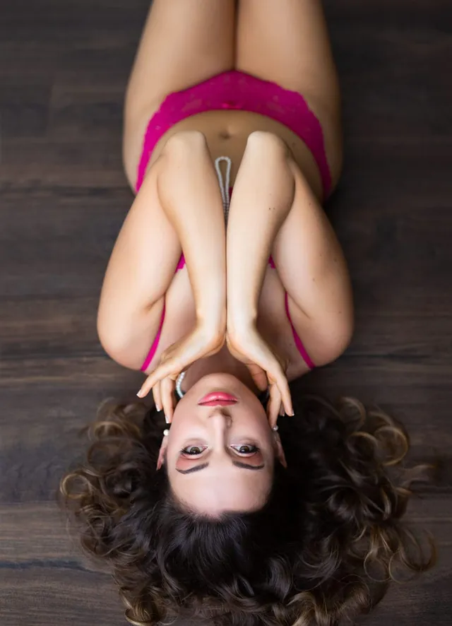 Maud allongée en lingerie rose, pose joueuse
